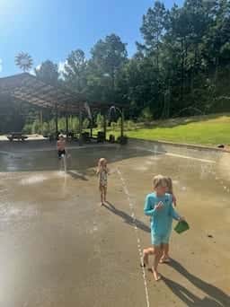 Children splashing in shallow water on a summer day